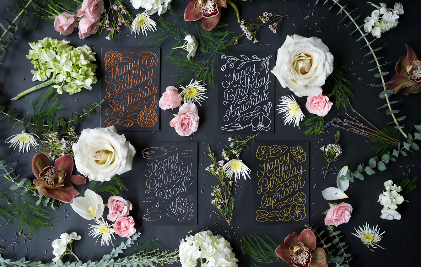 Black screen printed & foil stamped Zodiac Flora birthday cards for Saggitarius, Aquarius, Pisces and Capricorn. Designed by Gather & Seek (formerly Chelley Co.) in collaboration with Melissa Deckert.