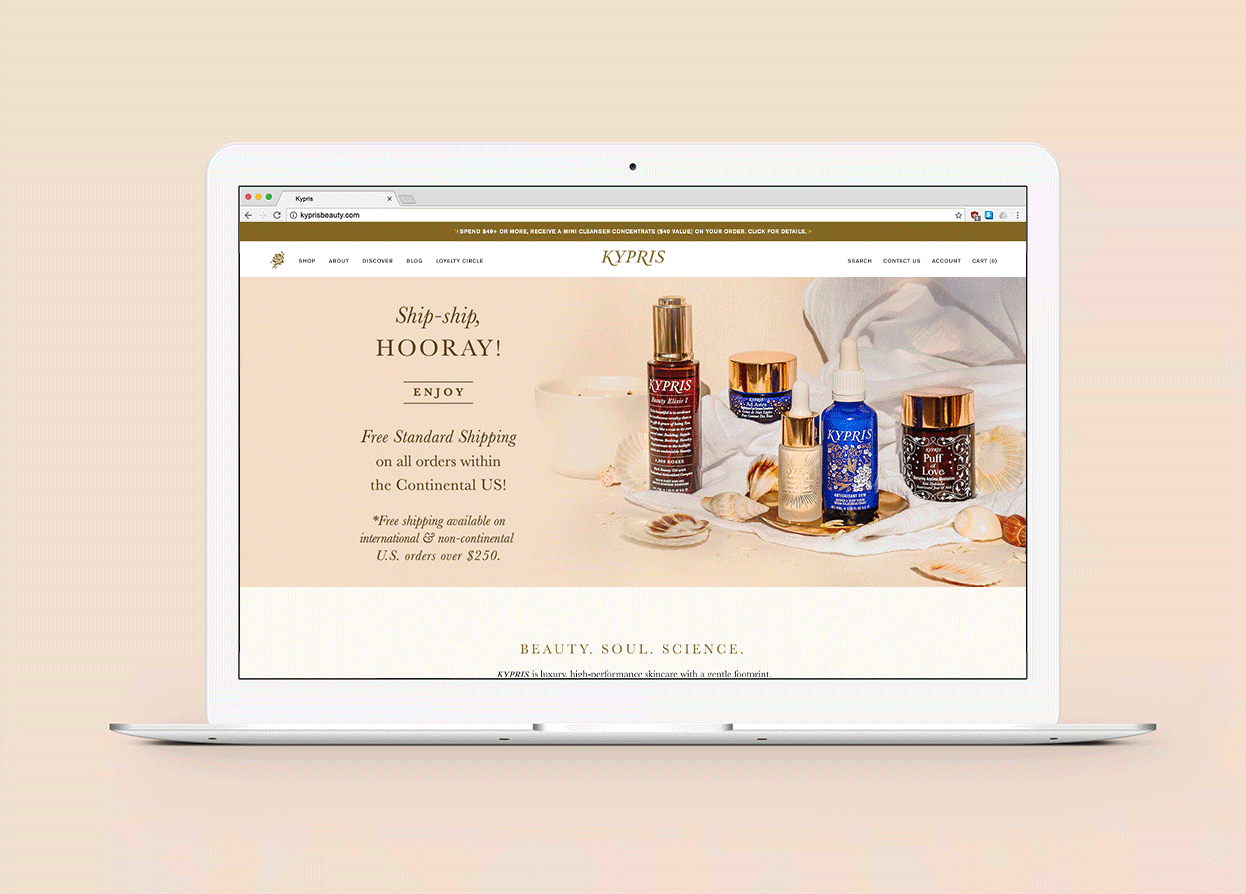 Laptop website mockup that showcases the homepage design for KYPRIS, on a peach toned background.