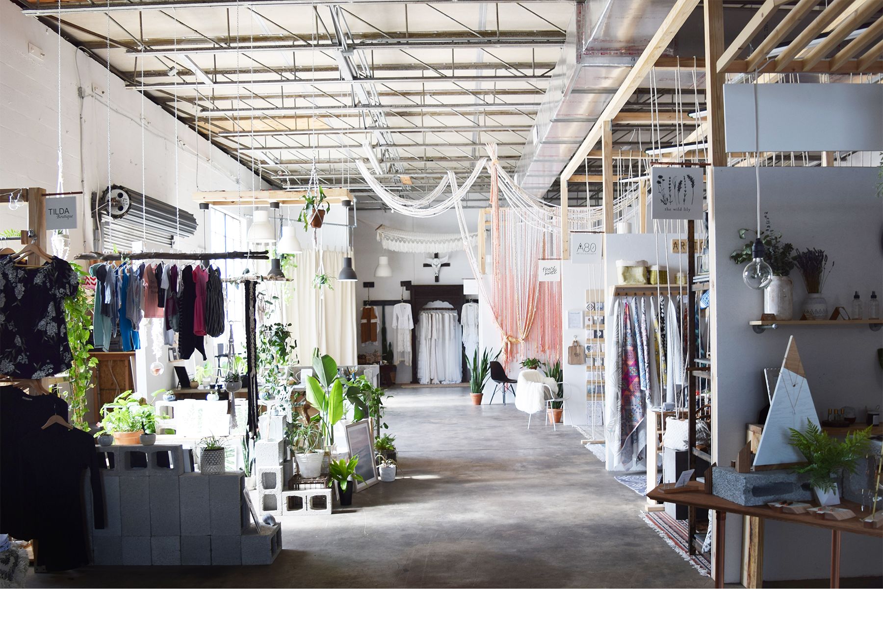 Elizabeth Ave Station's retail location in The Warehouse District of West Palm Beach, Florida featuring vendors products, an installation by Hayley Sheldon, and lush plants in an industrial vibe.